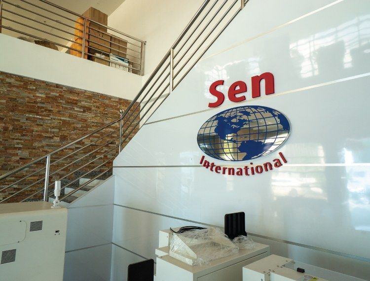 Sen International logo wall at the Sen office