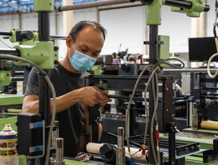 Sen technician working on a label machine